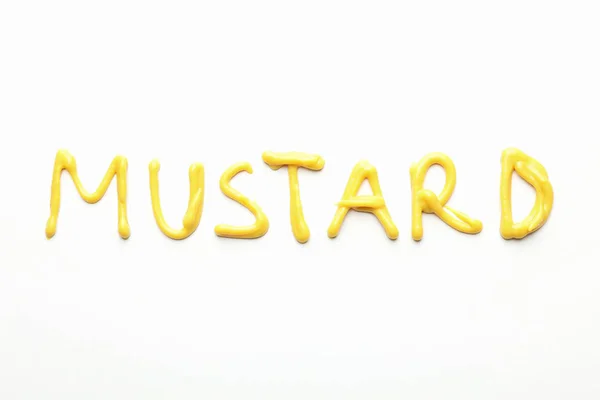 Επιγραφή Μουστάρδα από σάλτσα σε λευκό φόντο, πάνω όψη — Φωτογραφία Αρχείου