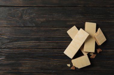 Sweet wafers on wooden background, space for text