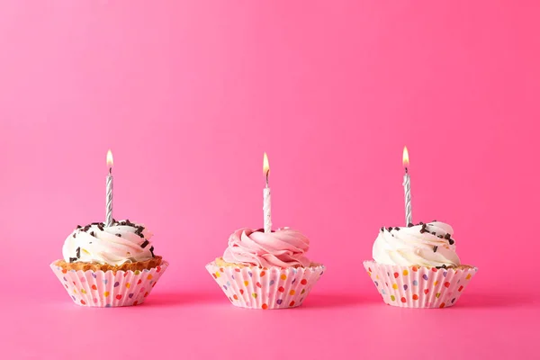 Cupcakes with candle on pink background, space for text — Stock Photo, Image