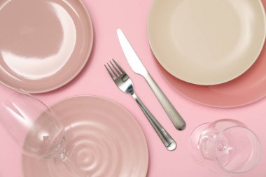 Pembe arka planda şarap kadehleri olan masa ayarı, üst görünüm