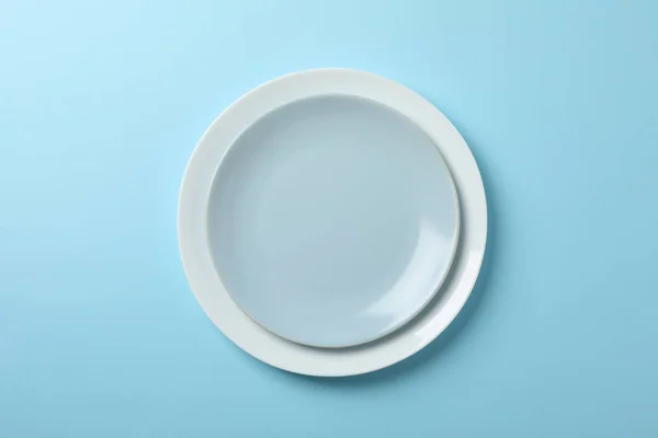 Plates on blue background, top view and space for text — 스톡 사진