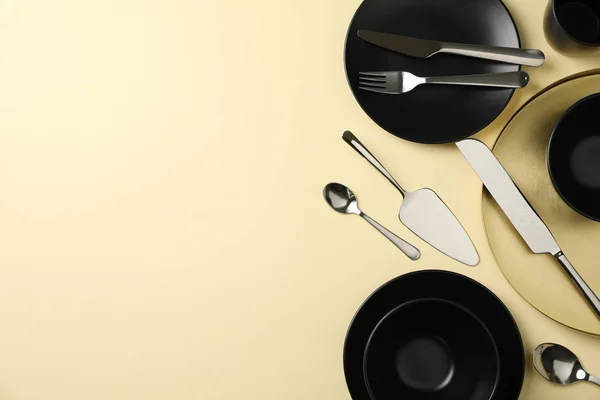 Tableware and cutlery on beige background, top view — 스톡 사진