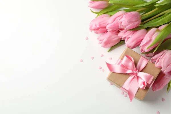 Beyaz arkaplanda laleler, hediye ve kalpler, metin için boşluk