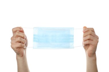 Ellerinde tıbbi koruyucu maske olan eller, beyaz sırt deliğinde izole edilmiş.
