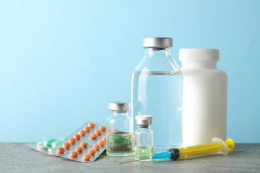 Medical composition, vaccine, syringe, thermometer on gray backg