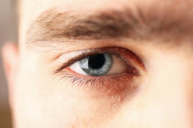 Beautiful mans blue eye, closeup. Macro. Healthcare and medical 