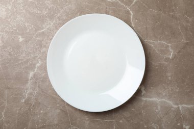Plate on grey background, top view and space for text