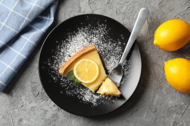 Limonlu turta dilimi ve gri arka planda havlu ve le.