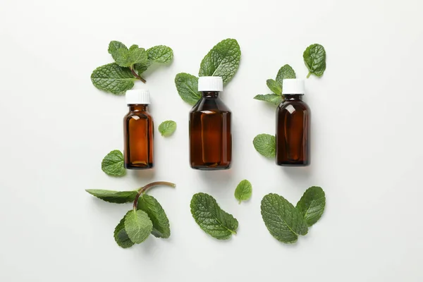 Medical bottles and mint on white background, space for text — Stock Photo, Image
