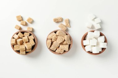Bowls with sugar on white background, top view