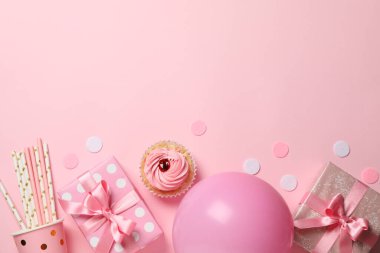 Composition with gift boxes and balloon on pink background, spac