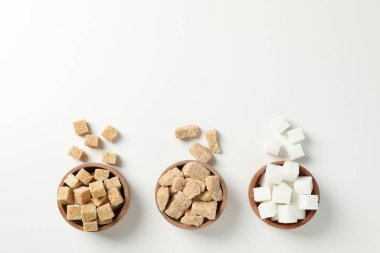 Bowls with sugar on white background, top view