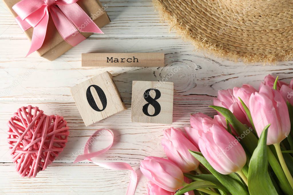 Composition with wood calendar and tulips on wooden background, 