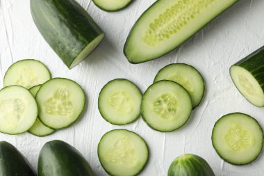 Beyaz arka planda salatalıklar ve dilimler, üst görünüm