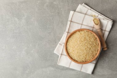 Pilavlı kase, havlu ve kaşık gri arka planda, üst manzara