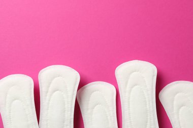 Sanitary pads frame on pink background, space for text clipart