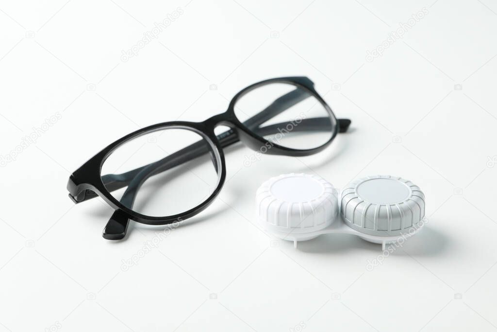 Gasses and contct lenses on white background, close up