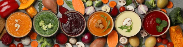 stock image Vegetable soups and ingredients on grey background, top view