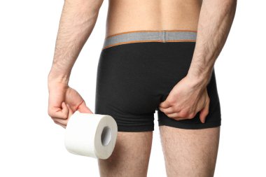 Man holding his butt and toilet paper, isolated on white background