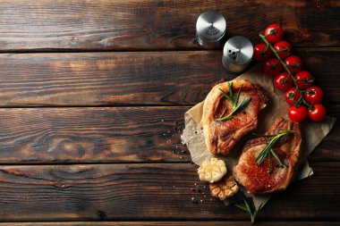 Ahşap arka planda kızarmış biftek kompozisyonu. Izgara yemek.