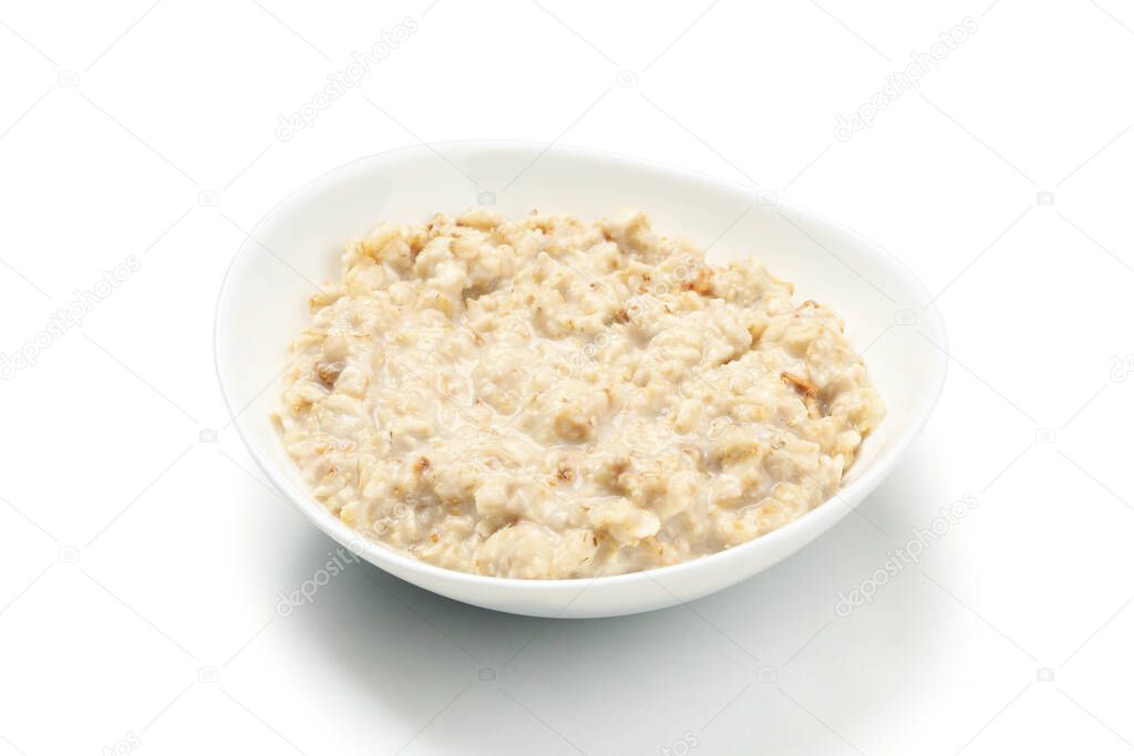Plate with cooked oatmeal isolated on white background