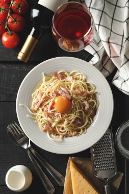 Lezzetli makarna ve ahşap arka planda yemek pişirmek için malzemeler içeren kompozisyon