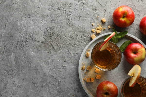 Composition with cider, sugar and apples on gray table