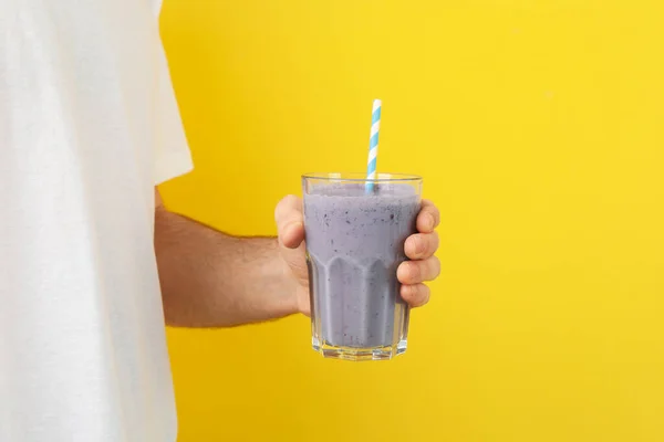 Young Man Holds Glass Berry Milkshake Yellow Background — Stock Photo, Image