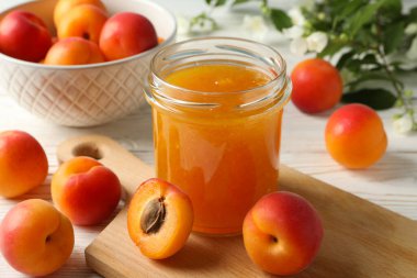 Lezzetli kayısılı kompozisyon ve beyaz ahşap masada reçel.