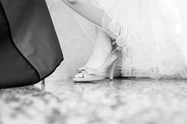 Sposa in un bellissimo abito da sposa mettere le scarpe — Foto Stock