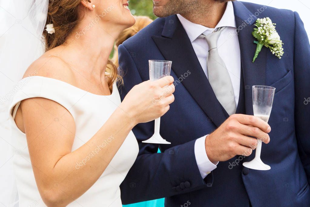 Bride and groom holding wedding champagne glasses