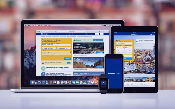 Booking.com on the Apple iPhone 7 iPad Pro Apple Watch and Macbook Pro — Stock Photo, Image