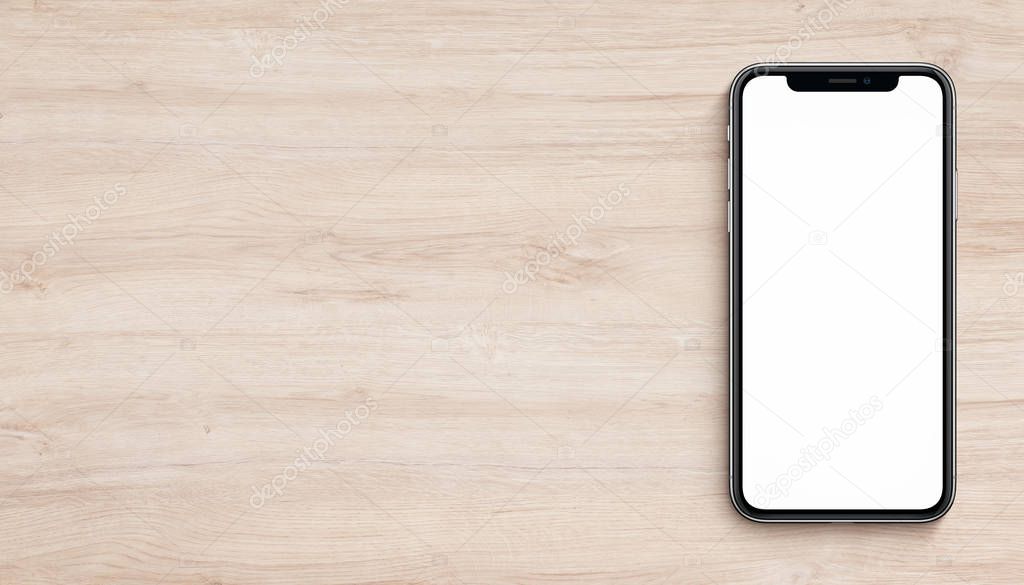 Smartphone mockup similar to iPhone X flat lay top view lying on wooden office desk banner with copy space