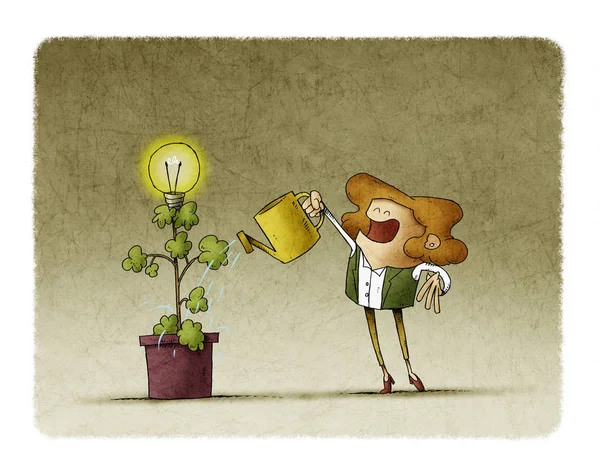 Bizneswoman podlewa roślinę, z której kwitnie żarówka. — Zdjęcie stockowe