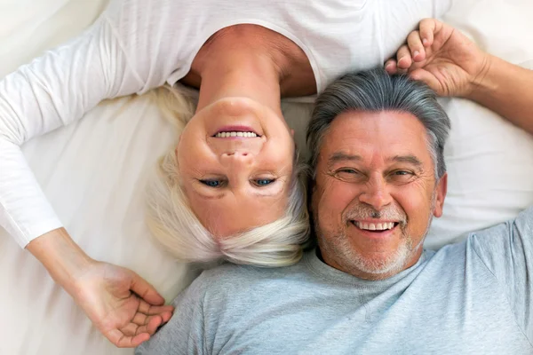 Seniorenpaar liegt zusammen im Bett — Stockfoto