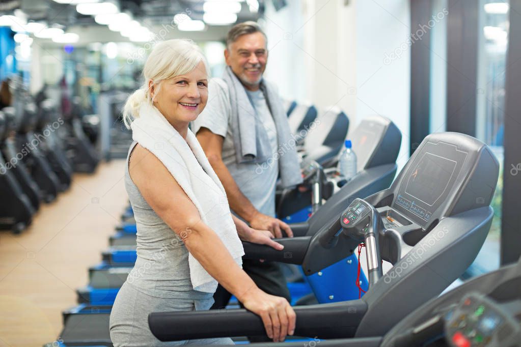 Senior couple exercising in gym