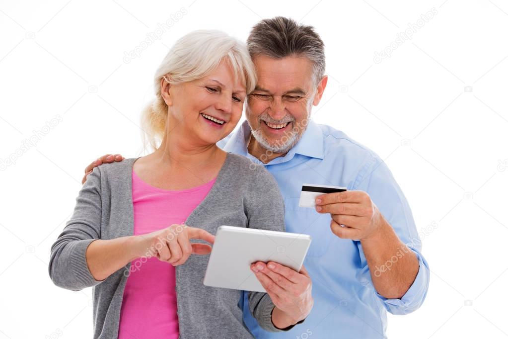Elderly couple having fun with technology