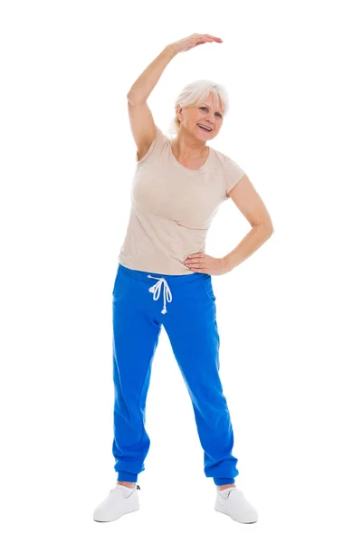 Senior vrouw doen fitness oefeningen — Stockfoto