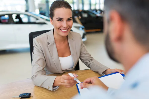 Female car dealer in showroom — Stock Photo, Image