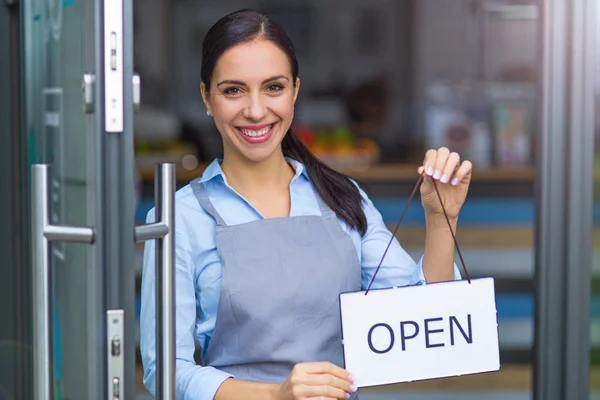 Kvinna som håller öppna logga in café — Stockfoto