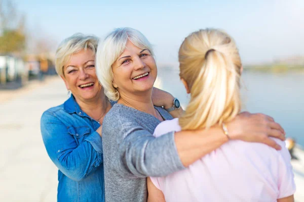 Group of smiling senior women standing outside — Stock Photo, Image