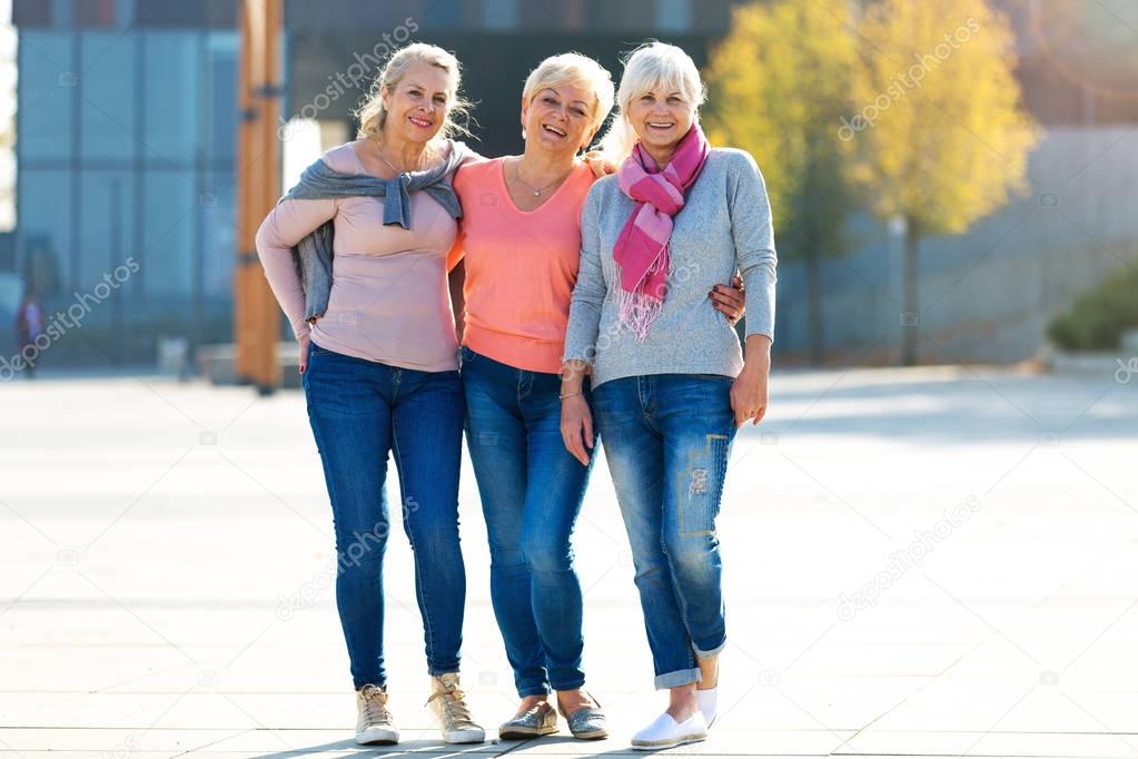Group of smiling senior women standing outside
