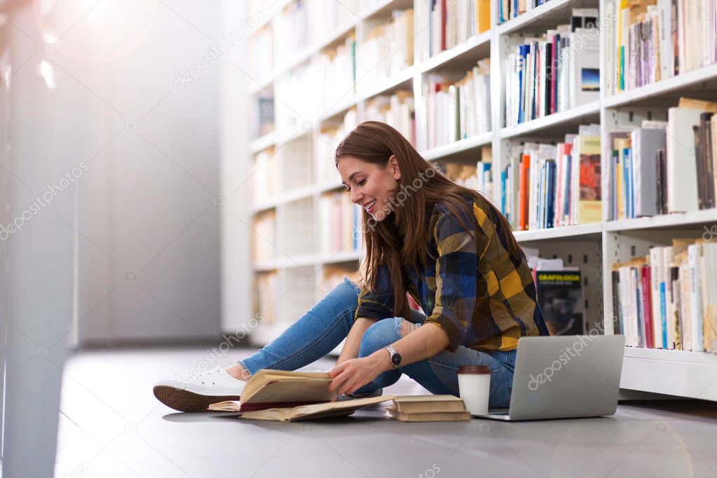 Young female student studying in the library