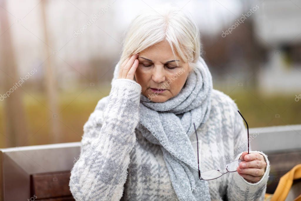 Senior woman suffering from a headache 