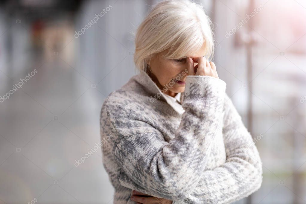 Senior woman suffering from a headache 