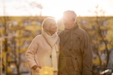 Senior couple hugging outdoors in autumn