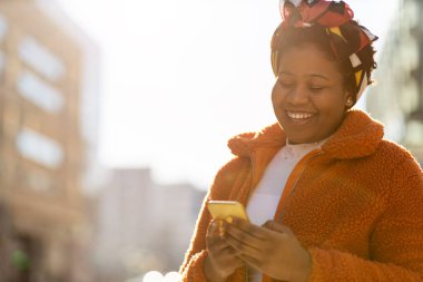 Young woman with smartphone in an urban city area