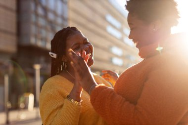 İki güzel Afro-Amerikan kadını şehirde birlikte eğleniyor.