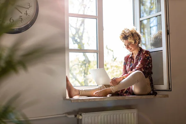 Young Woman Sitting Window Sill Using Laptop Royalty Free Stock Images