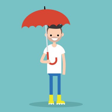Karakter sarı lastik çizme giyen şemsiye ile gülümseyen genç